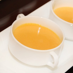 Yellow pudding in white bowl