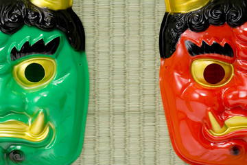 Masks of a red devil and a blue devil