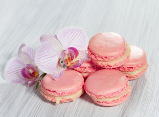 Obraz na płótnie Canvas Pink French macarons on a wooden background.