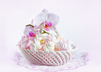 Delicate meringue with a pink orchid