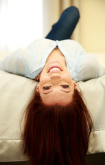 Fototapeta premium Funny smiling woman lying on the bed at home