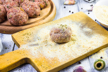 process rolling raw meatballs breadcrumbs