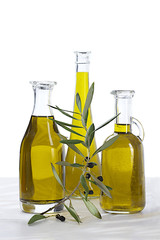 pure of oil bottles and raw black olives branch