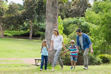 Parents and kids walking in park