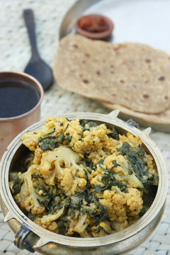 An Indian dish consisting of cauliflower and spinach