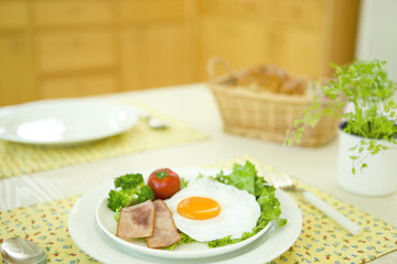 Breakfast of fried egg and chervil on a table