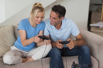 Couple playing video games in living room