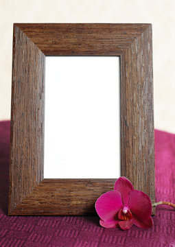 Empty picture frame and orchid