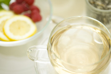 Glass cup of herb tea and lemon