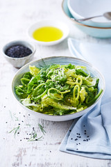 Bowl of Green Salad made with  Lettuce, Leek and Sesame Seeds
