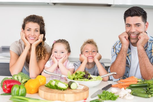 Cheerful family preparing vegetables together