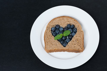 a piece of bread with the middle filled with blueberries