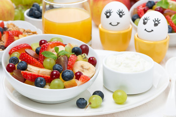 fresh fruit salad, cream and painted eggs for breakfast