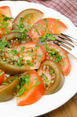 salad of two varieties of tomatoes with fresh parsley vertical