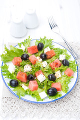 salad with watermelon, feta cheese and olives, vertical