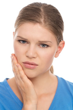 Dental care. Young woman suffering from toothache, isolated