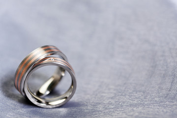 Wedding rings on silver cloth with copy space