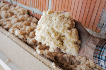dry wood fiber blown-in in front of a brick masonry