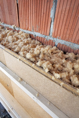 dry wood fiber blown-in in front of a brick masonry