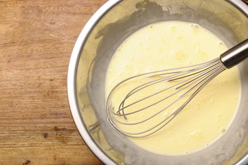 Manual whisk mixing cream and egg - 61676092
