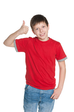 Young Boy In The Red Shirt Holds His Thumb Up