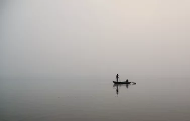 Deurstickers lone fisherman in the river © Mivr