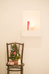 Christmas tree decorated over chair