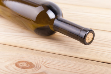 Obraz na płótnie Canvas Bottle of wine on a wooden table.