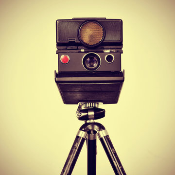 old instant camera in a tripod