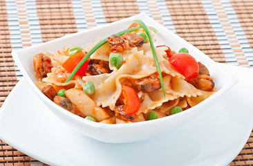Farfalle pasta with seafood, cherry tomatoes and green peas