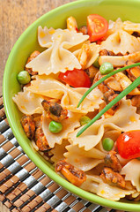Farfalle pasta with seafood, cherry tomatoes and green peas