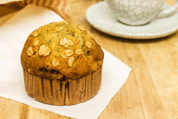 Almond muffins with coffee cup on wood table