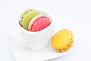 colorful macaroon in a cup on white background