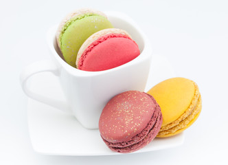 colorful macaroon in a cup on white background