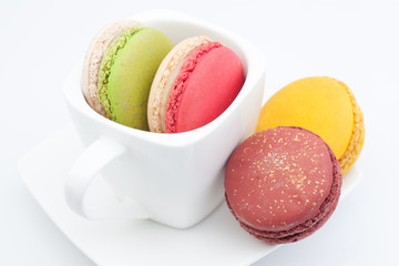 colorful macaroon in a cup on white background
