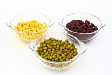The peas, red bean, corn in glass dish on the white background