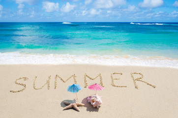 Sign "Summer" on the sandy beach with starfish and seashell