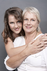 Beautiful Adult Daughter holding hug her Mother