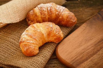 Two croissants on a linen cloth