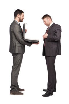 smiling businessman showing briefcase