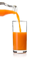 Carrot juice pouring into glass