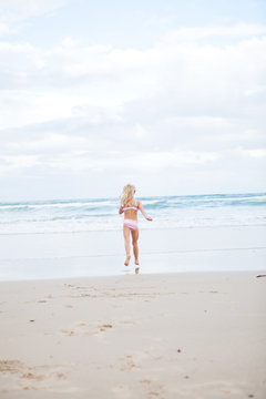 Young girl running at beach