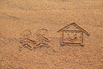 Happy lover and house with smile icon drawn on beach sand