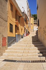 Fototapeta na wymiar Old Narrow Street and Stairs Sidewalk in Biar Alicante