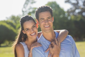 Loving and happy young couple at park