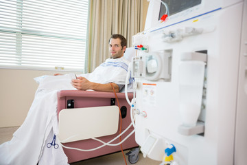 Patient Holding Cellphone During Renal Dialysis Treatment