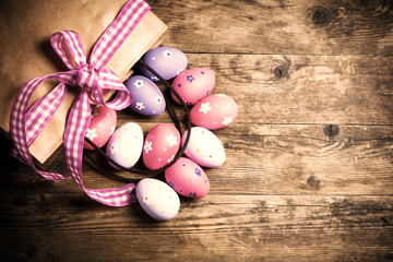 Fototapeta na wymiar Easter eggs painted on the wooden background.
