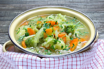 Vegetable soup with cabbage, broccoli, potatoes and carrots
