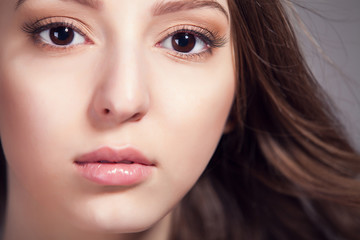 Portrait of beautiful woman over gray background