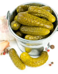 pickled cucumbers in a metal bucket isolated on white